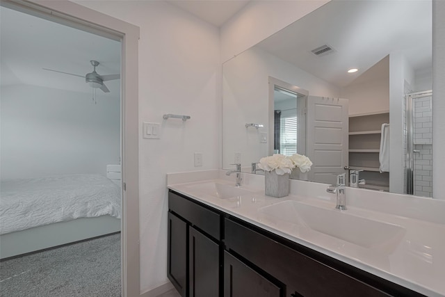 ensuite bathroom featuring double vanity, a ceiling fan, visible vents, and a sink
