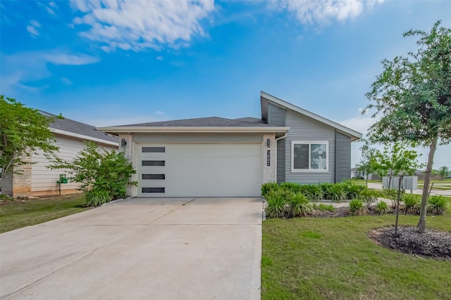 view of front of property with a garage, driveway, and a front lawn