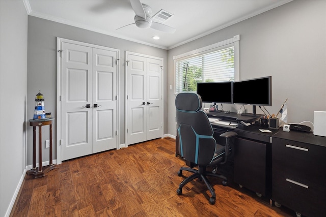 office area with a ceiling fan, baseboards, wood finished floors, visible vents, and ornamental molding