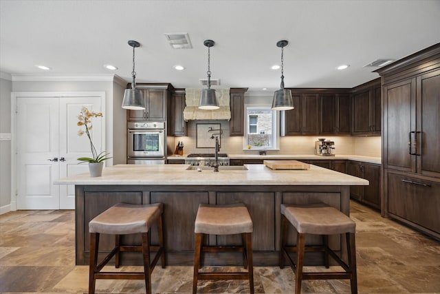 kitchen featuring range hood, ornamental molding, dark brown cabinets, and visible vents