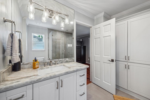 bathroom featuring vanity, ornamental molding, a stall shower, and toilet