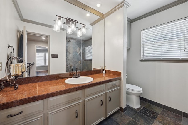 full bathroom with vanity, ornamental molding, toilet, baseboards, and a stall shower