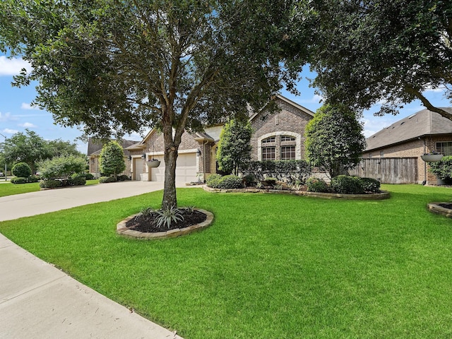view of front of house featuring concrete driveway, fence, a front yard, and a garage