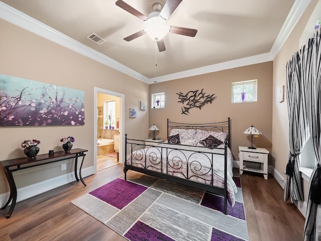 bedroom with visible vents, ornamental molding, baseboards, and wood finished floors