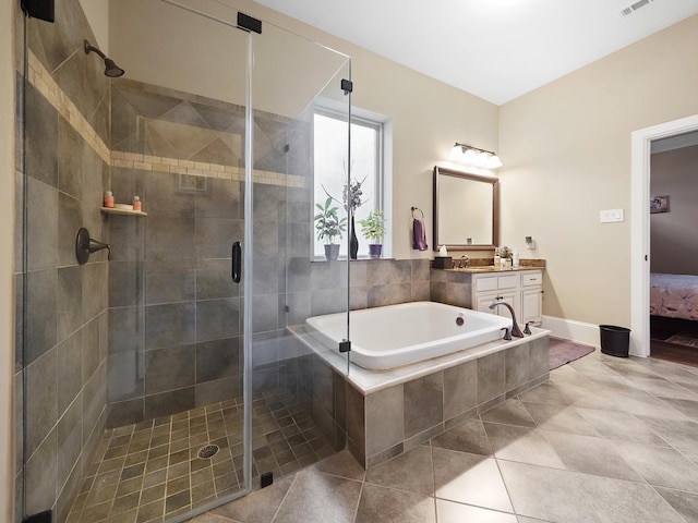 ensuite bathroom with vanity, ensuite bathroom, a bath, tile patterned floors, and a shower stall