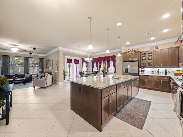 kitchen featuring appliances with stainless steel finishes, ornamental molding, light tile patterned floors, and visible vents