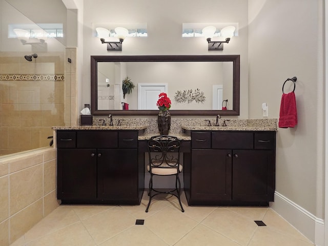bathroom with tile patterned flooring, walk in shower, and vanity