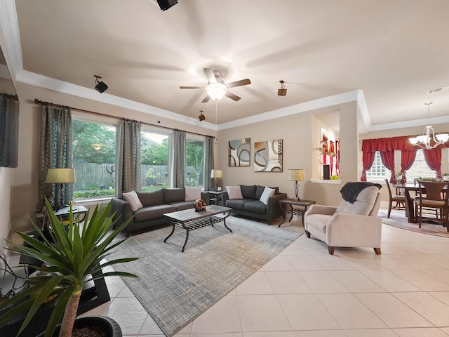 living room featuring crown molding, a wealth of natural light, light tile patterned floors, and ceiling fan with notable chandelier