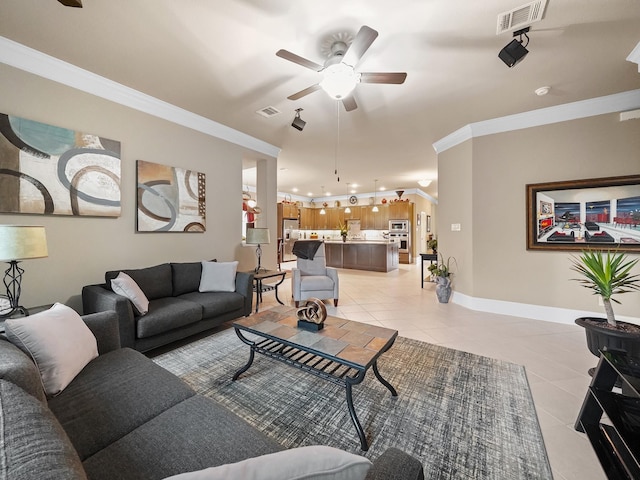 living room with visible vents, ornamental molding, ceiling fan, and light tile patterned flooring