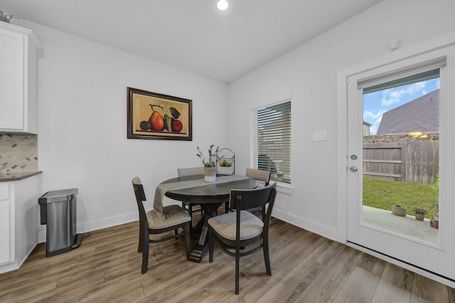 9911 Silverling Ct, Conroe, TX 77385 - dining space featuring baseboards, light wood finished floors, and a wealth of natural light