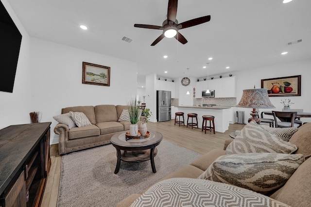 9911 Silverling Ct, Conroe, TX 77385 - living room with visible vents, recessed lighting, light wood-style floors, and ceiling fan