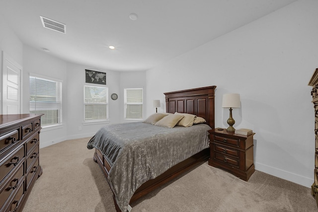 9911 Silverling Ct, Conroe, TX 77385 - bedroom featuring baseboards, light carpet, and visible vents