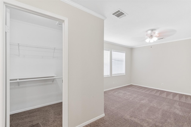 unfurnished bedroom with visible vents, carpet, crown molding, and baseboards
