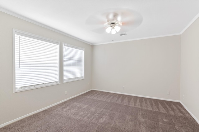 spare room with crown molding, baseboards, carpet, and a ceiling fan
