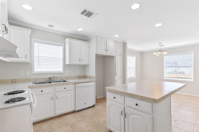 kitchen with visible vents, a sink, a healthy amount of sunlight, and white appliances