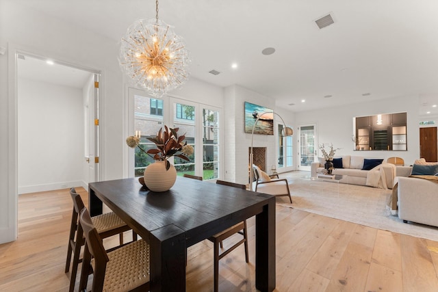 2530 Stanmore Dr, Houston, TX 77019 - dining space featuring a chandelier, light wood finished floors, recessed lighting, and plenty of natural light