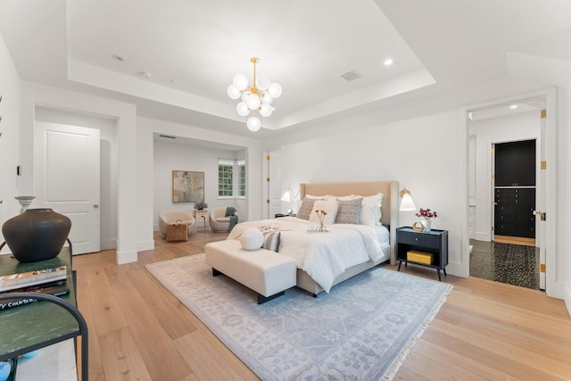 2530 Stanmore Dr, Houston, TX 77019 - bedroom with a raised ceiling, a chandelier, light wood finished floors, baseboards, and recessed lighting