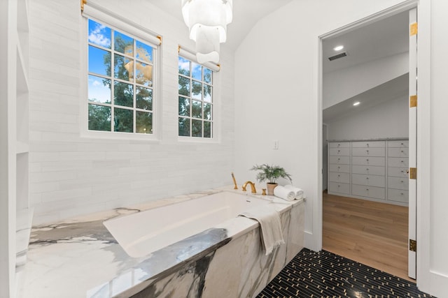 2530 Stanmore Dr, Houston, TX 77019 - full bathroom featuring vaulted ceiling, a garden tub, wood finished floors, and recessed lighting