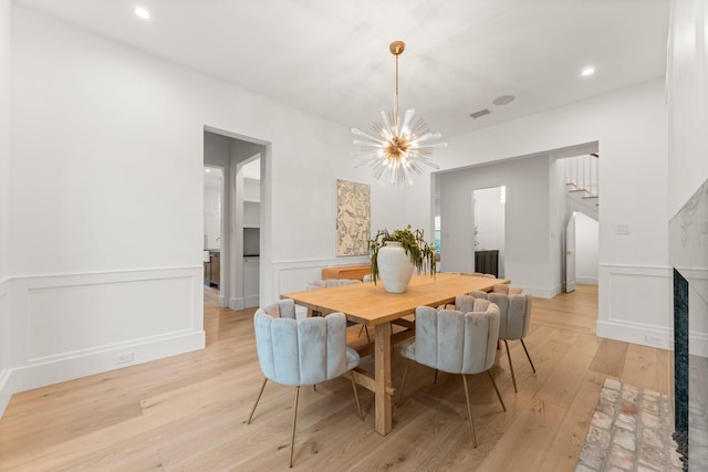2530 Stanmore Dr, Houston, TX 77019 - dining space with light wood-style floors, a chandelier, wainscoting, stairway, and recessed lighting