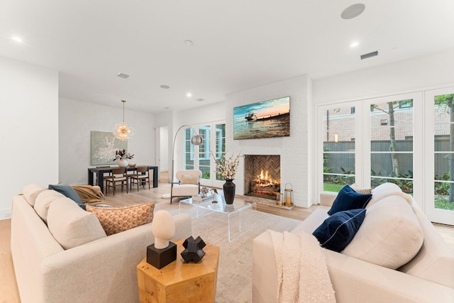 2530 Stanmore Dr, Houston, TX 77019 - living area with plenty of natural light, a brick fireplace, wood finished floors, and recessed lighting