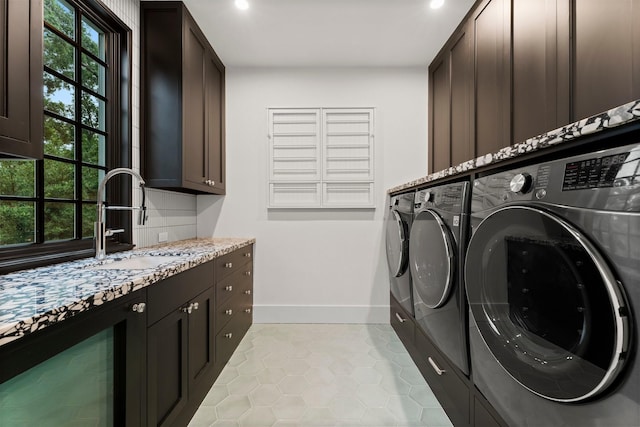 2530 Stanmore Dr, Houston, TX 77019 - laundry room featuring cabinet space, washing machine and clothes dryer, light tile patterned floors, beverage cooler, and recessed lighting