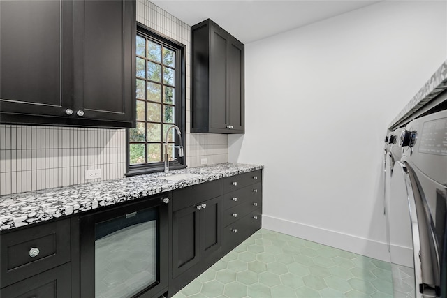 2530 Stanmore Dr, Houston, TX 77019 - kitchen with a sink, wine cooler, light tile patterned floors, baseboards, and decorative backsplash