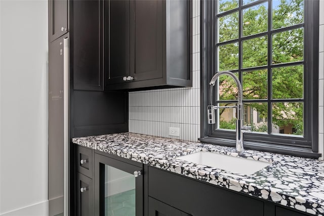 2530 Stanmore Dr, Houston, TX 77019 - kitchen featuring a sink, beverage cooler, decorative backsplash, and light stone counters
