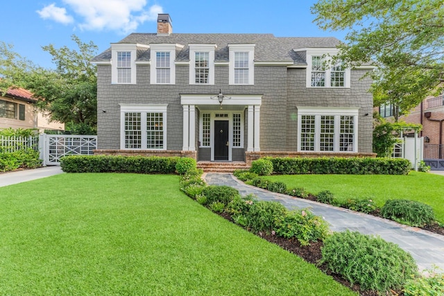 2530 Stanmore Dr, Houston, TX 77019 - shingle-style home featuring a chimney, a shingled roof, and a gate