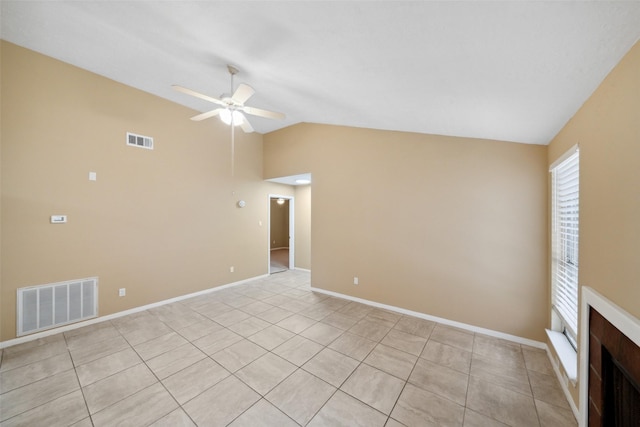 unfurnished living room featuring visible vents, a ceiling fan, lofted ceiling, and light tile patterned flooring