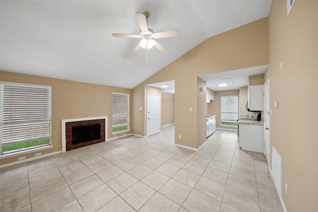 unfurnished living room featuring visible vents, a fireplace, ceiling fan, light tile patterned floors, and vaulted ceiling