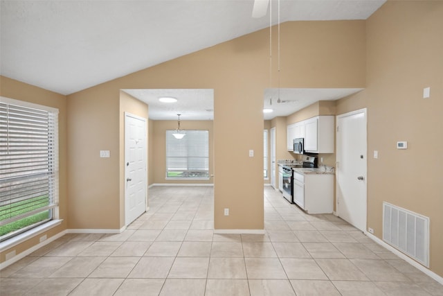 unfurnished living room with baseboards, visible vents, light tile patterned floors, and high vaulted ceiling