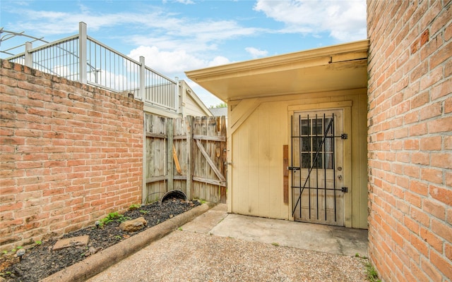 entrance to property featuring fence
