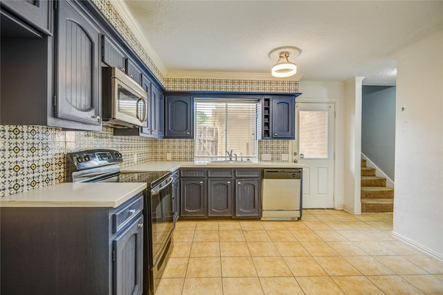 kitchen with electric range, crown molding, dishwasher, a sink, and stainless steel microwave