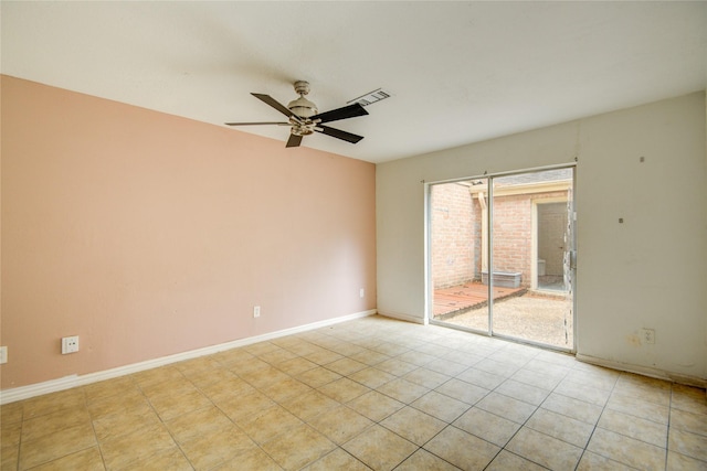 empty room with baseboards, a ceiling fan, and visible vents