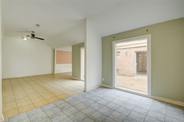 tiled empty room with baseboards, ceiling fan, visible vents, and lofted ceiling
