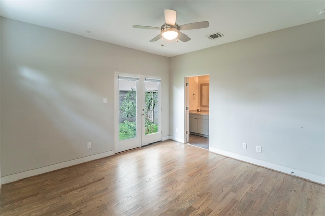 unfurnished room with ceiling fan, visible vents, baseboards, and light wood-type flooring