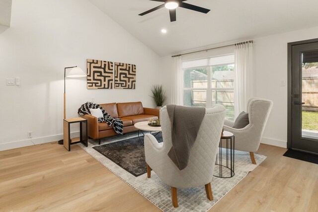 living area featuring plenty of natural light, ceiling fan, and light wood-style flooring