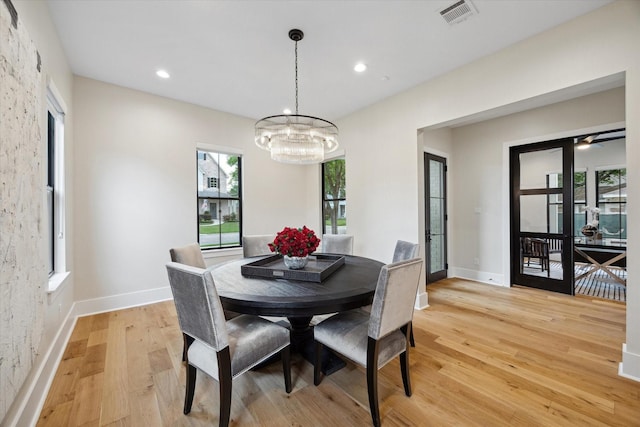 dining area featuring visible vents, recessed lighting, a notable chandelier, and light wood-type flooring