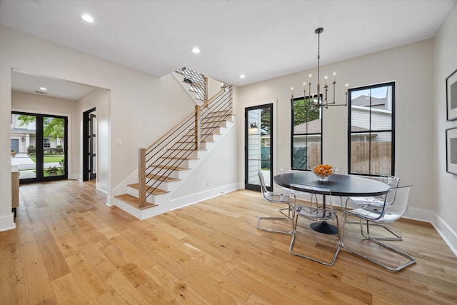 dining space with stairway, baseboards, a notable chandelier, recessed lighting, and light wood-style flooring