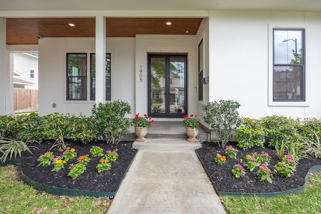 property entrance featuring a porch and stucco siding