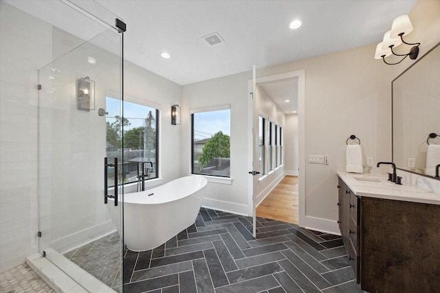 bathroom featuring vanity, recessed lighting, visible vents, a soaking tub, and a stall shower