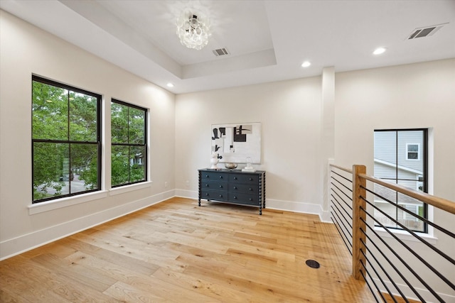spare room featuring recessed lighting, light wood finished floors, a chandelier, and visible vents