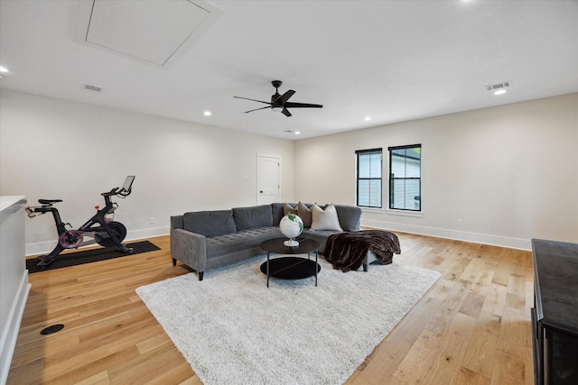 living area with recessed lighting, baseboards, light wood finished floors, and visible vents
