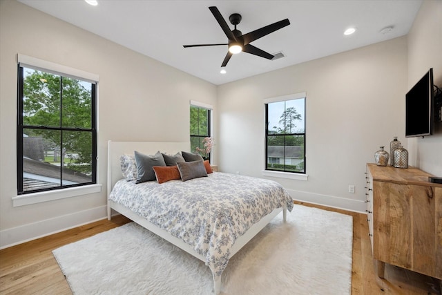 bedroom with light wood-style floors, baseboards, a ceiling fan, and recessed lighting