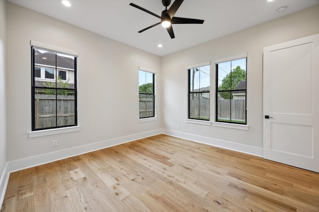empty room featuring recessed lighting, baseboards, ceiling fan, and light wood finished floors
