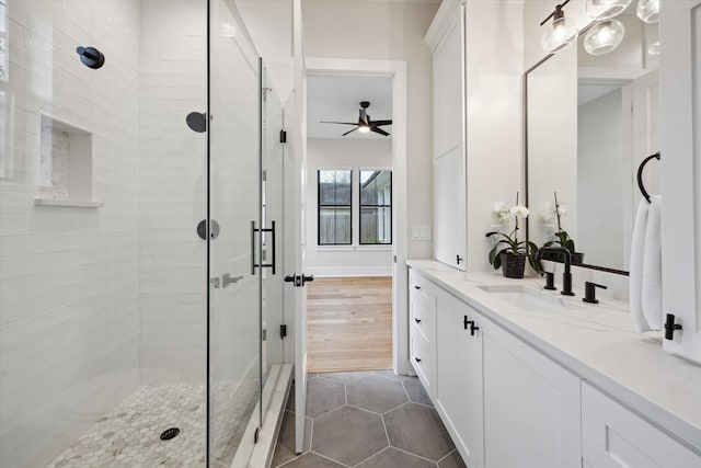 bathroom featuring vanity, ceiling fan, tile patterned floors, and a stall shower