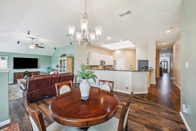 dining area with baseboards, visible vents, ceiling fan with notable chandelier, and dark wood-type flooring