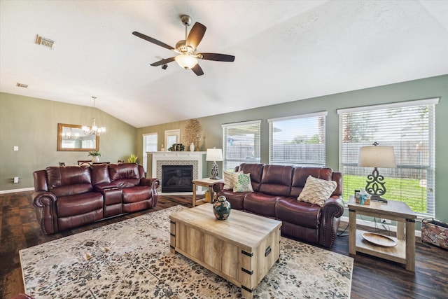 living room featuring visible vents, ceiling fan with notable chandelier, wood finished floors, and vaulted ceiling