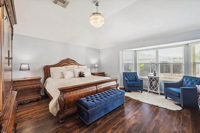 bedroom with visible vents, multiple windows, vaulted ceiling, and hardwood / wood-style floors