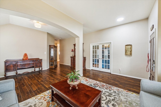living room with french doors, arched walkways, wood finished floors, baseboards, and recessed lighting